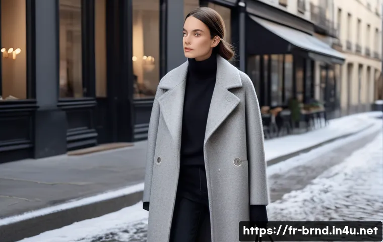 아미와 생로랑의 겨울 아우터 비교 - A refined urban winter scene featuring a model wearing an Ami coat made of natural merino wool and c...